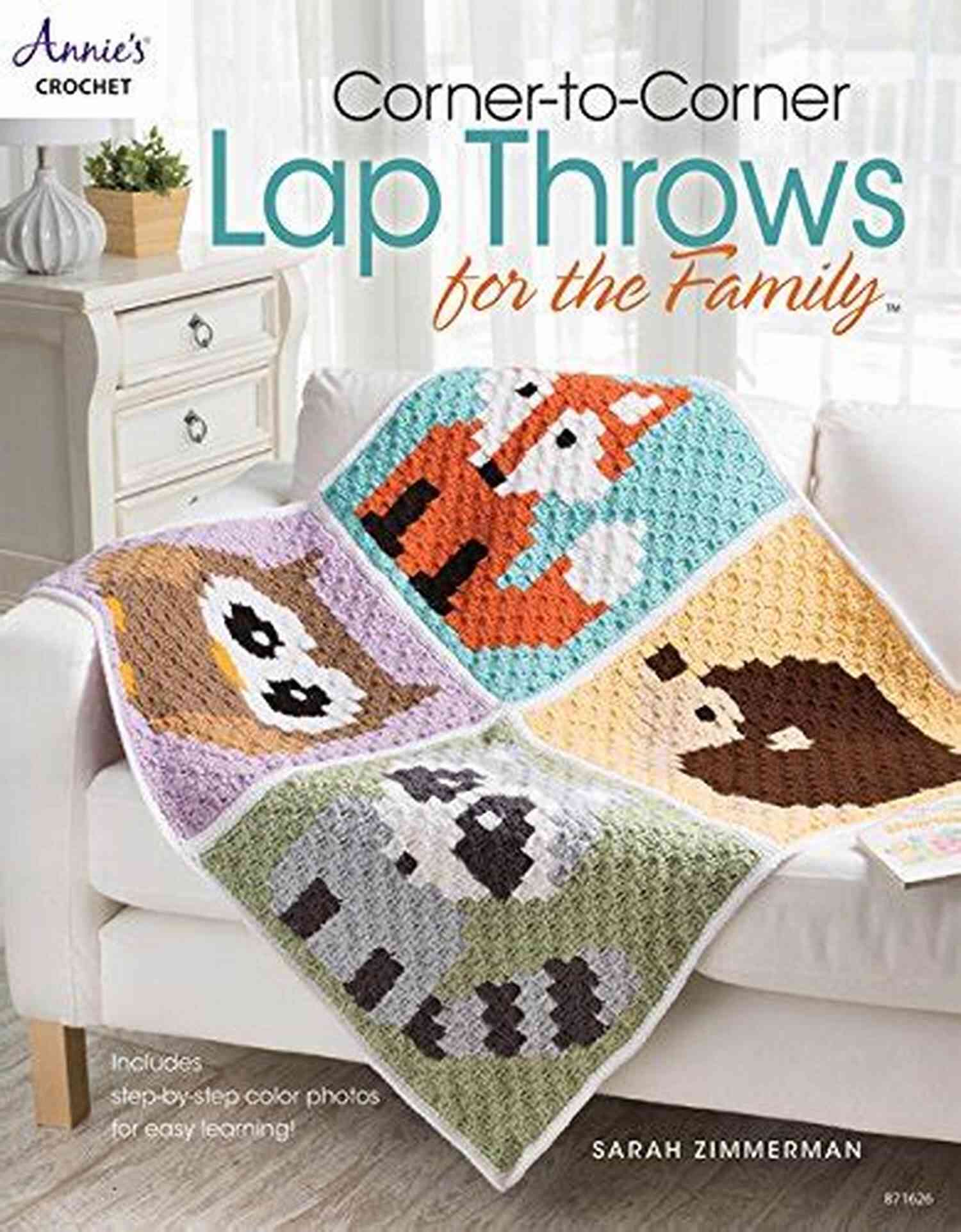 A Corner To Corner Lap Throw Being Held Close By A Child, Helping Them Feel Cozy And Secure Corner To Corner Lap Throws For The Family (Annies Crochet)